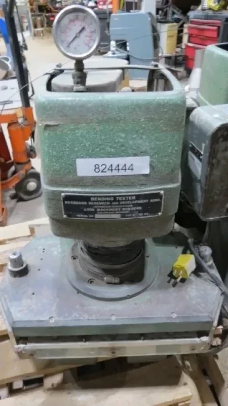 Boxboard Bending Tester - The BRDA bending tester scores and folds paperboard, using different combinations of rule and die widths and die penetration depths. Folds the board along the score line. The unit is self-contained hydraulic, using 110VAC electrical supply.